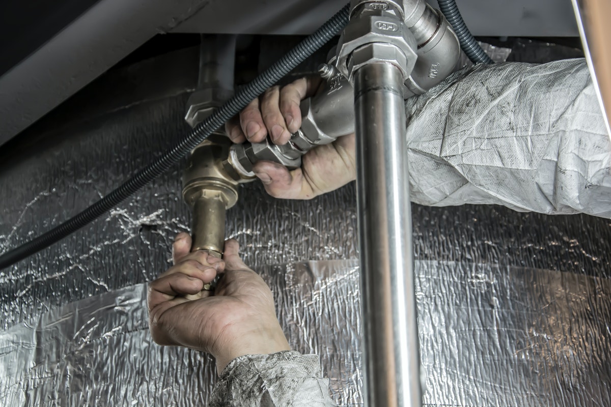 man fixing a pipe